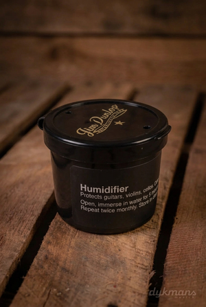 Zwarte Dunlop HE360 humidifier met gouden Jim Dunlop-logo en witte zijtekst op een warme houten achtergrond